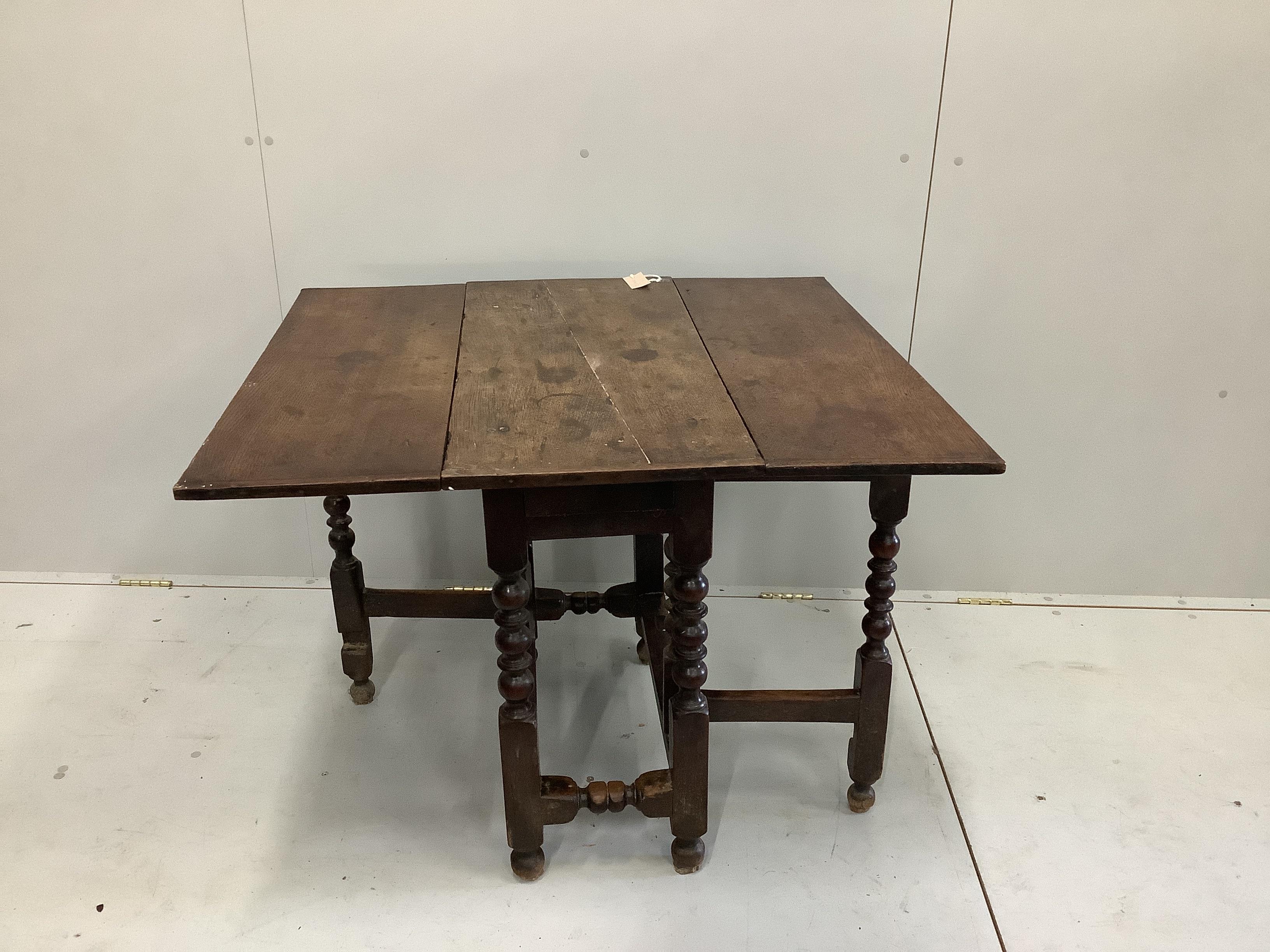 A small 18th century and later oak drop flap table, width 38cm, depth 82cm, height 71cm